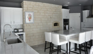 Marble countertops in kitchen with minted art on wall